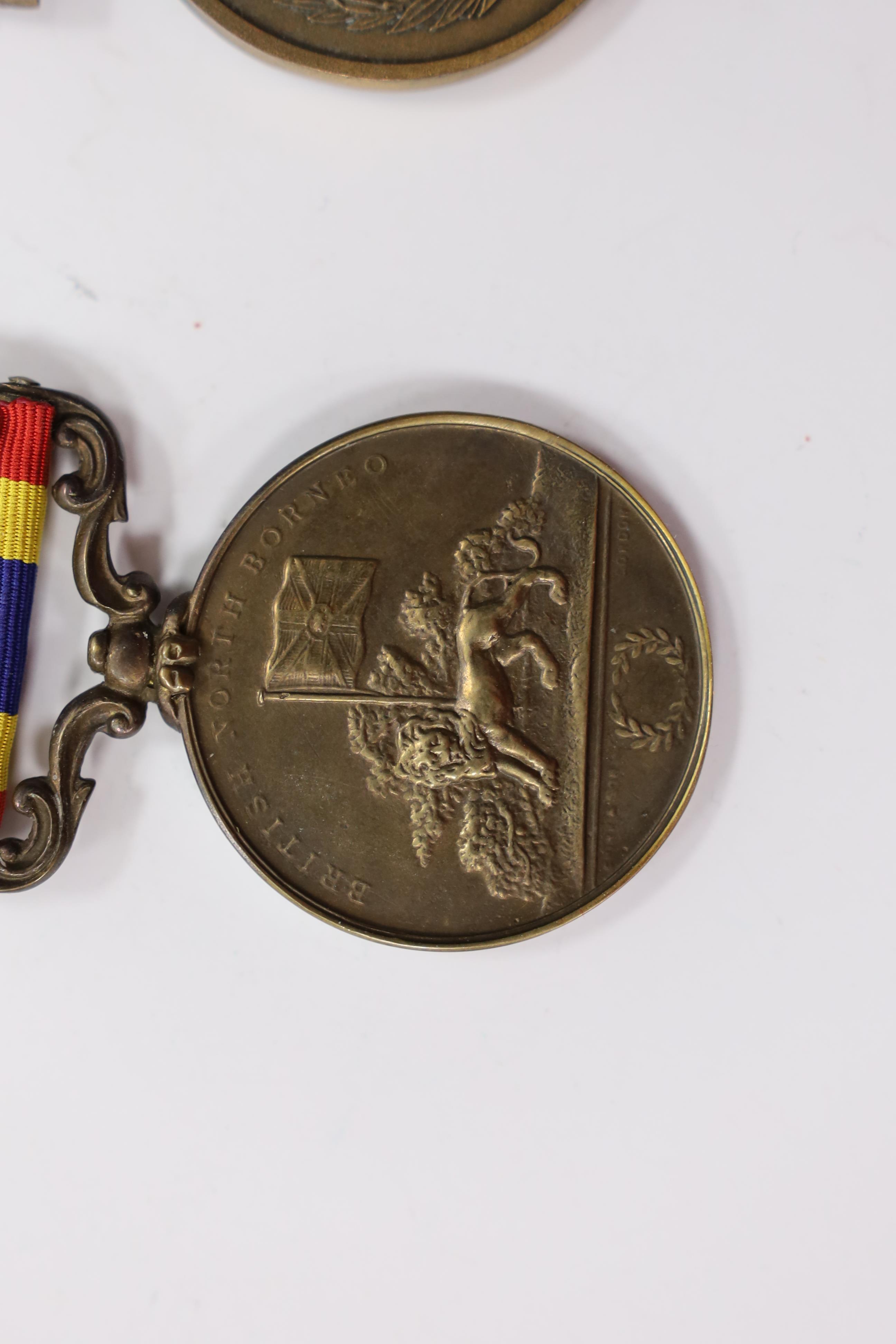 Assorted medals; two replica British North Borneo medals; Balaklava medallion; bronze GV medal; German China Campaign medal; bronze NRA medallion, unnamed